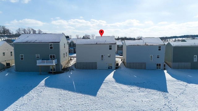 view of snow covered rear of property