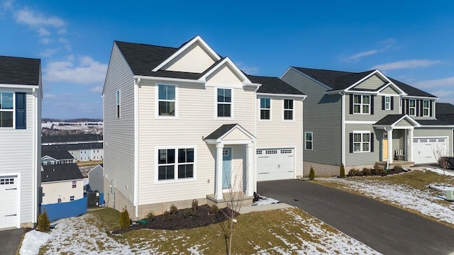 view of front of home with a garage and central air condition unit