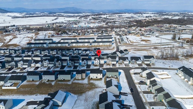 snowy aerial view with a mountain view