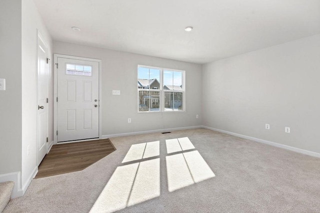 view of carpeted entrance foyer