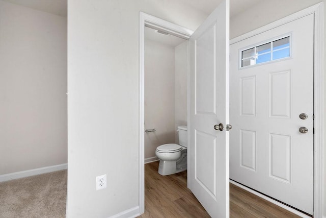 bathroom featuring hardwood / wood-style floors and toilet