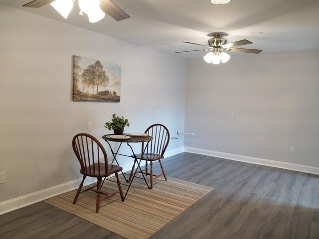 dining space featuring dark wood-type flooring and ceiling fan