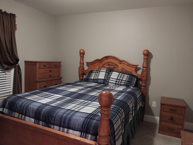 bedroom with dark colored carpet