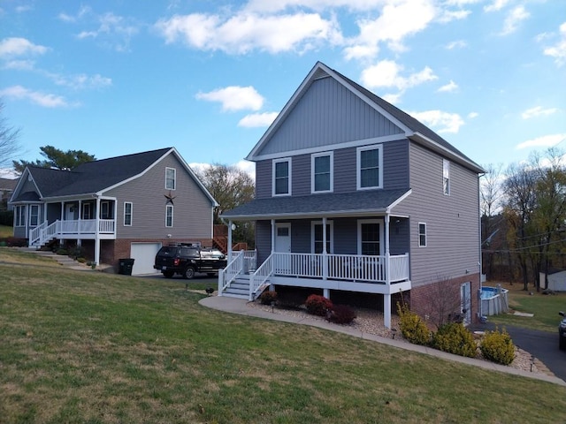 view of front of house featuring a garage, a front yard, and covered porch