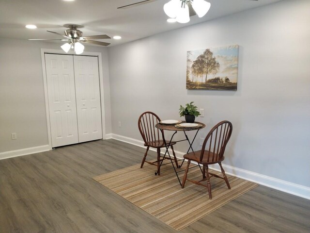 dining space featuring ceiling fan and dark hardwood / wood-style flooring