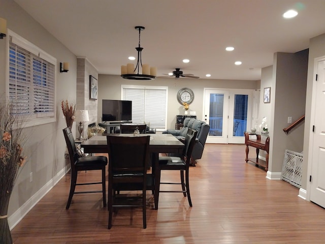 dining room with hardwood / wood-style floors and ceiling fan