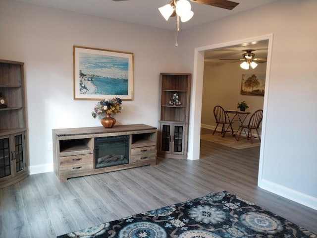 living room featuring ceiling fan and light hardwood / wood-style floors