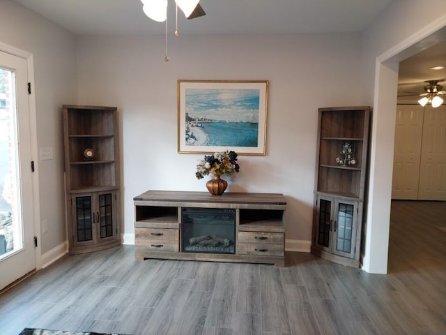 unfurnished living room with light hardwood / wood-style floors and ceiling fan