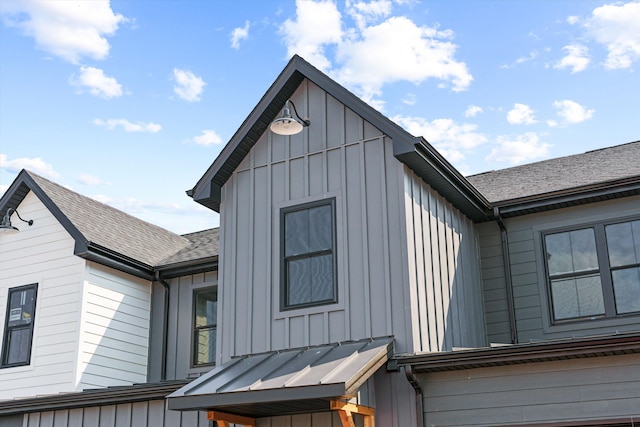 view of property exterior featuring roof with shingles and board and batten siding