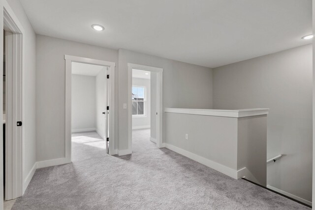 spare room featuring baseboards, carpet flooring, and recessed lighting