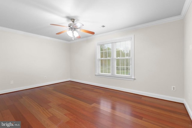 spare room with visible vents, baseboards, a ceiling fan, hardwood / wood-style flooring, and crown molding