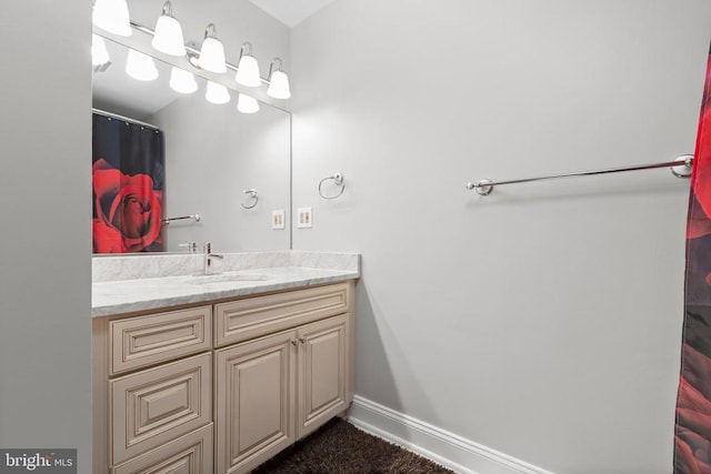 full bathroom with baseboards and vanity