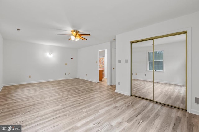 unfurnished bedroom with light wood-type flooring, baseboards, and ceiling fan