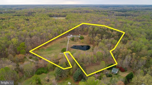 birds eye view of property with a forest view