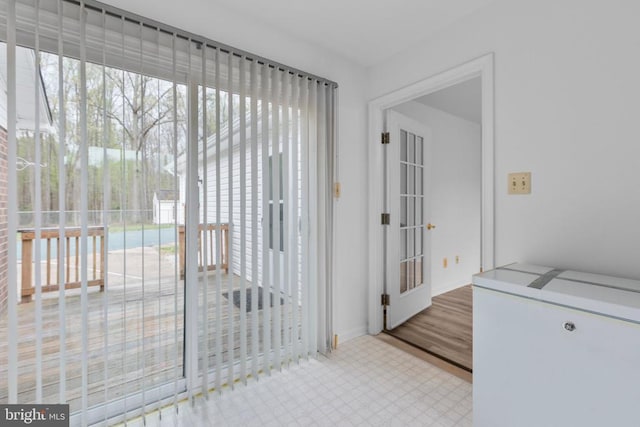 doorway to outside featuring baseboards
