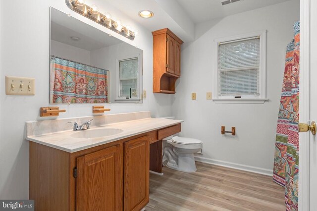 bathroom featuring visible vents, baseboards, toilet, vanity, and wood finished floors