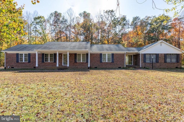ranch-style home with a front yard, brick siding, and crawl space