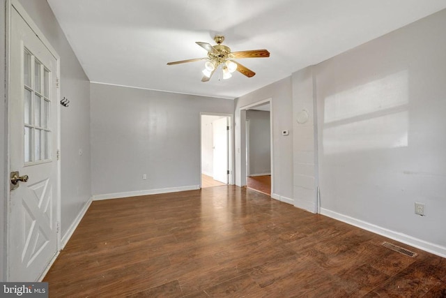 spare room with visible vents, baseboards, ceiling fan, and wood finished floors