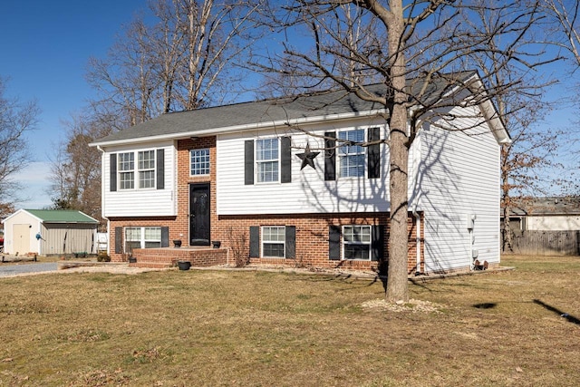 raised ranch featuring a front yard and a storage unit