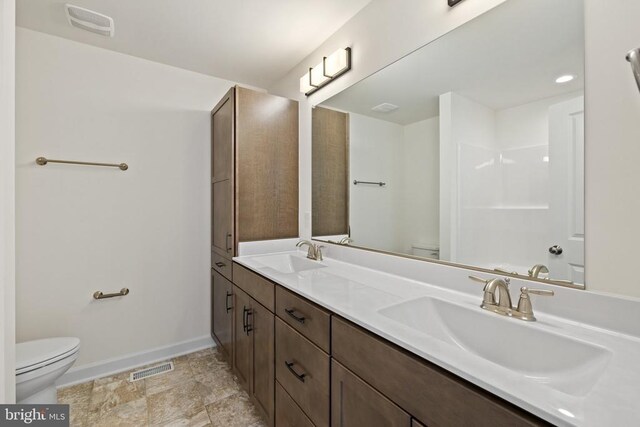 bathroom featuring vanity and toilet