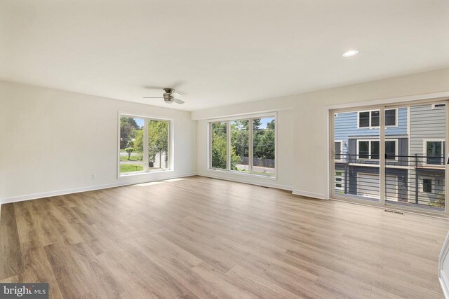 unfurnished living room with ceiling fan and light hardwood / wood-style floors