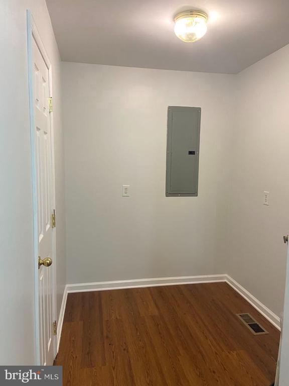 interior space featuring dark hardwood / wood-style floors and electric panel