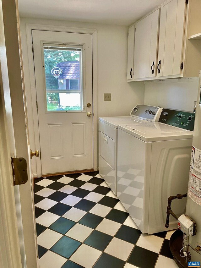 laundry room featuring separate washer and dryer and cabinets