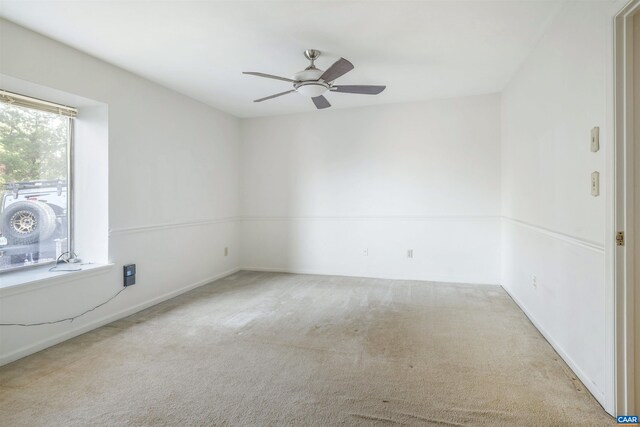 empty room with light colored carpet and ceiling fan