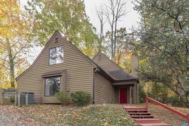 view of side of home with central AC unit