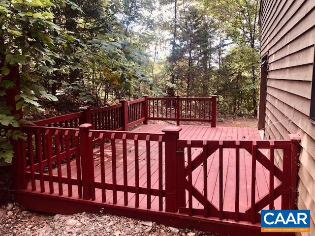 view of gate featuring a wooden deck