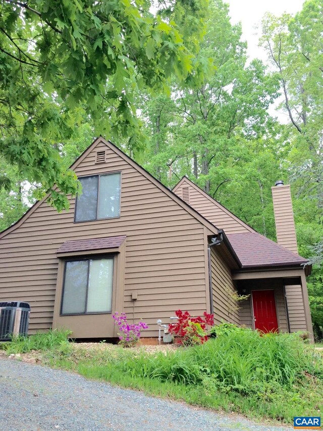 view of side of property featuring central AC