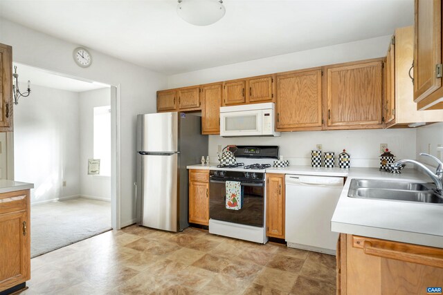 kitchen featuring sink and white appliances