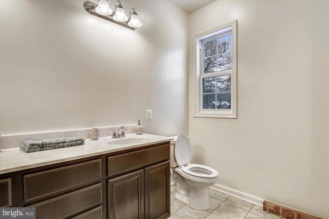 bathroom with vanity, toilet, and tile patterned flooring