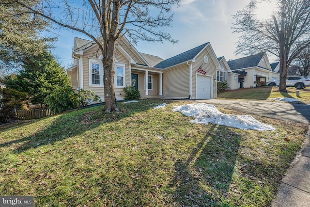 view of front of property with a garage and a front yard