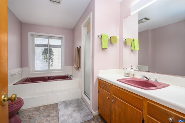 full bathroom featuring vanity, separate shower and tub, and toilet