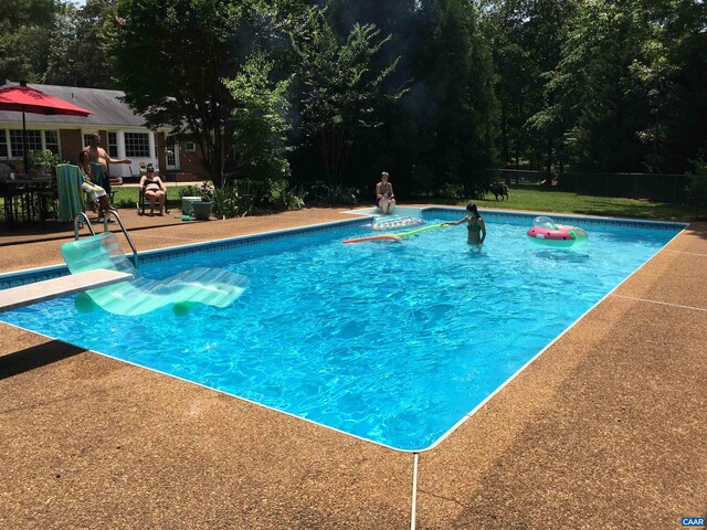 view of swimming pool featuring a patio area