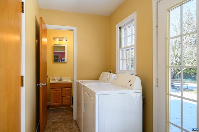 washroom featuring washing machine and clothes dryer and sink