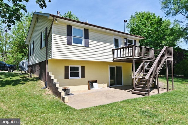 rear view of property featuring a lawn, central AC unit, a deck, and stairway