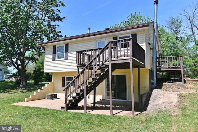 rear view of house featuring a wooden deck, stairs, a lawn, and a patio