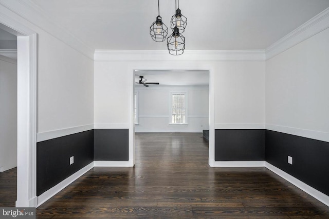 unfurnished dining area featuring baseboards, wood finished floors, a ceiling fan, and crown molding