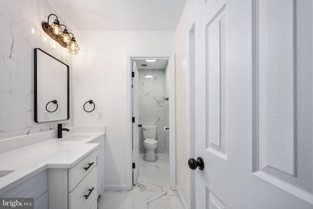 full bathroom featuring toilet, a sink, baseboards, marble finish floor, and double vanity