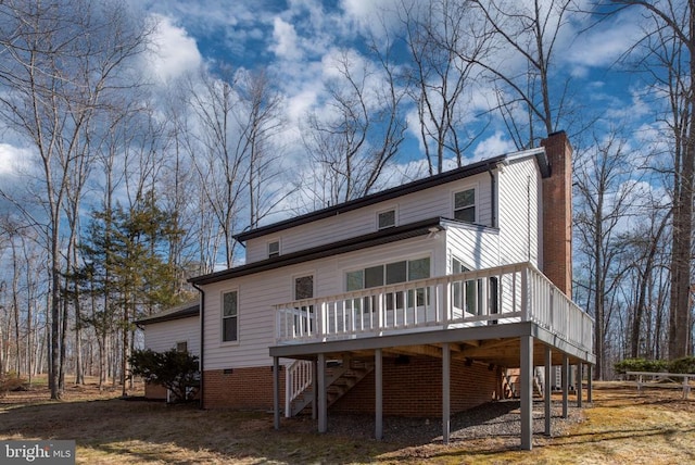 view of front facade featuring a carport, driveway, a chimney, and stairs