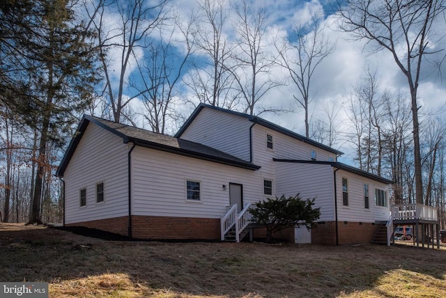 view of home's exterior featuring a deck and stairs