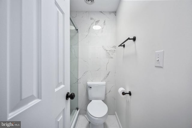 bathroom with toilet, marble finish floor, and a stall shower