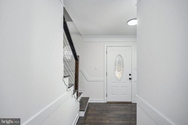 foyer entrance with baseboards, stairway, dark wood finished floors, and ornamental molding