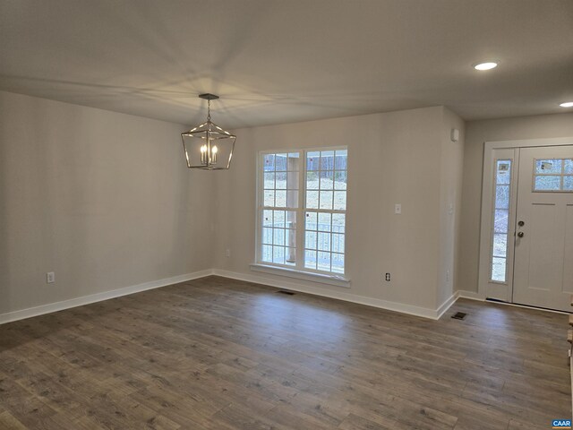 entryway featuring a notable chandelier and dark hardwood / wood-style floors