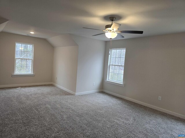 additional living space featuring lofted ceiling, ceiling fan, and carpet flooring