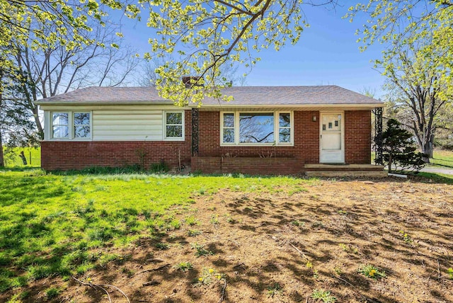 single story home featuring brick siding and a front lawn