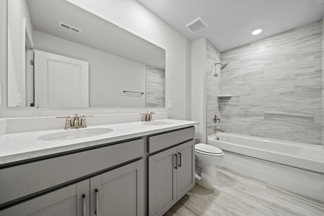 bathroom with toilet, visible vents, and a sink