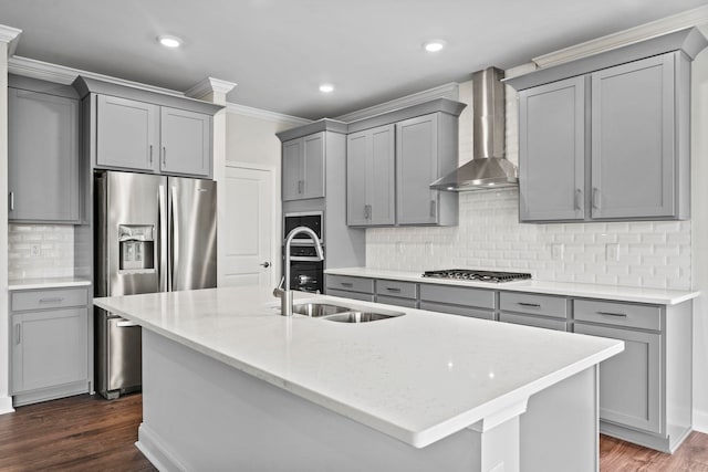 kitchen featuring an island with sink, ornamental molding, gray cabinets, dark wood-style floors, and wall chimney exhaust hood